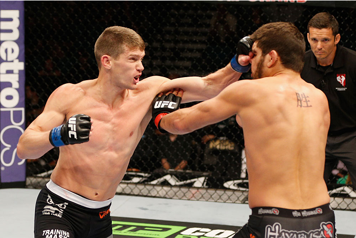 LAS VEGAS, NV - SEPTEMBER 27: (L-R) Stephen Thompson punches Patrick Cote in their welterweight fight during the UFC 178 event inside the MGM Grand Garden Arena on September 27, 2014 in Las Vegas, Nevada. (Photo by Josh Hedges/Zuffa LLC/Zuffa LLC via Ge