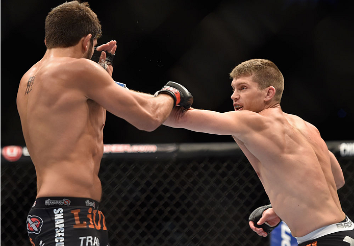 LAS VEGAS, NV - SEPTEMBER 27: (R-L) Josh Thompson punches Patrick Cote in their welterweight fight during the UFC 178 event inside the MGM Grand Garden Arena on September 27, 2014 in Las Vegas, Nevada. (Photo by Jeff Bottari/Zuffa LLC/Zuffa LLC via Gett