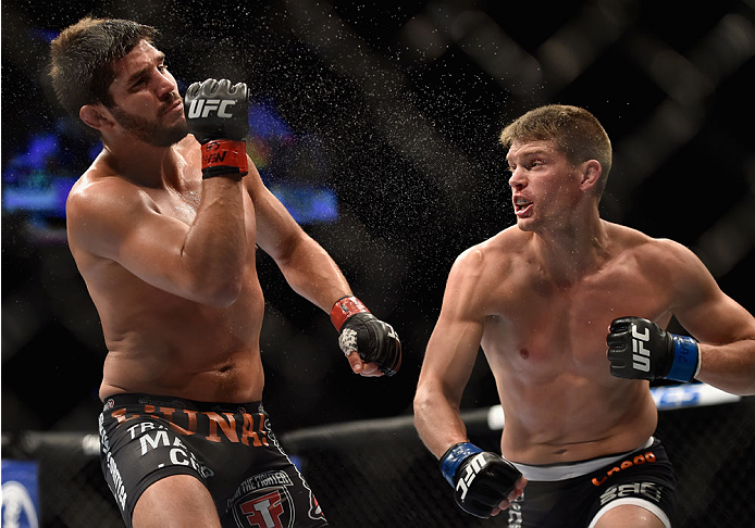 LAS VEGAS, NV - SEPTEMBER 27: (R-L) Josh Thompson punches Patrick Cote in their welterweight fight during the UFC 178 event inside the MGM Grand Garden Arena on September 27, 2014 in Las Vegas, Nevada. (Photo by Jeff Bottari/Zuffa LLC/Zuffa LLC via Gett