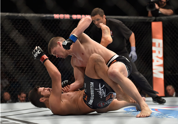 LAS VEGAS, NV - SEPTEMBER 27: (Top) Josh Thompson punches Patrick Cote in their welterweight fight during the UFC 178 event inside the MGM Grand Garden Arena on September 27, 2014 in Las Vegas, Nevada. (Photo by Jeff Bottari/Zuffa LLC/Zuffa LLC via Gett