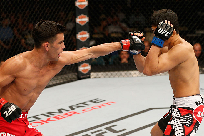 LAS VEGAS, NV - SEPTEMBER 27: (L-R) Dominick Cruz punches Takeya Mizugaki in their bantamweight fight during the UFC 178 event inside the MGM Grand Garden Arena on September 27, 2014 in Las Vegas, Nevada. (Photo by Josh Hedges/Zuffa LLC/Zuffa LLC via Ge