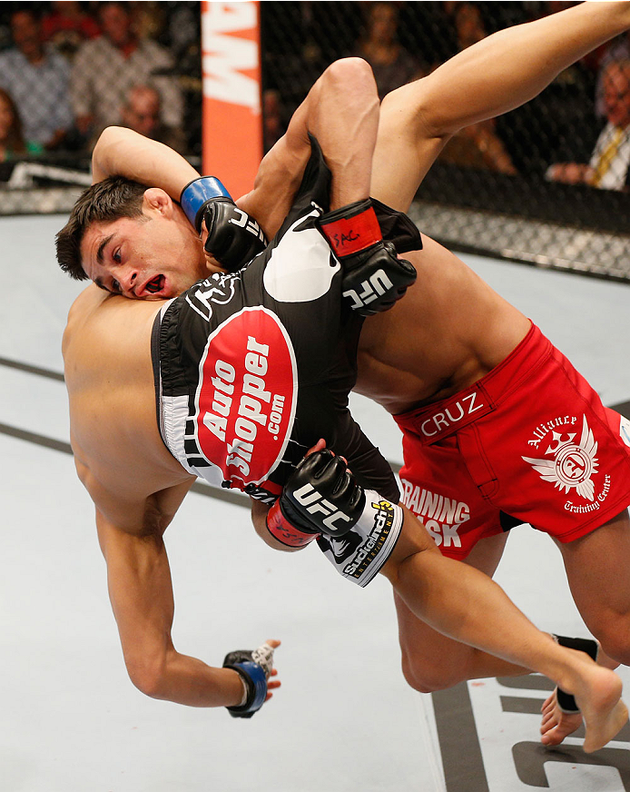 LAS VEGAS, NV - SEPTEMBER 27: (L-R) Dominick Cruz takes down Takeya Mizugaki in their bantamweight fight during the UFC 178 event inside the MGM Grand Garden Arena on September 27, 2014 in Las Vegas, Nevada. (Photo by Josh Hedges/Zuffa LLC/Zuffa LLC via