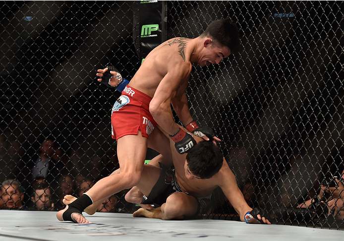 LAS VEGAS, NV - SEPTEMBER 27: (L-R) Dominick Cruz punches Takeya Mizugaki in their bantamweight fight during the UFC 178 event inside the MGM Grand Garden Arena on September 27, 2014 in Las Vegas, Nevada. (Photo by Jeff Bottari/Zuffa LLC/Zuffa LLC via G