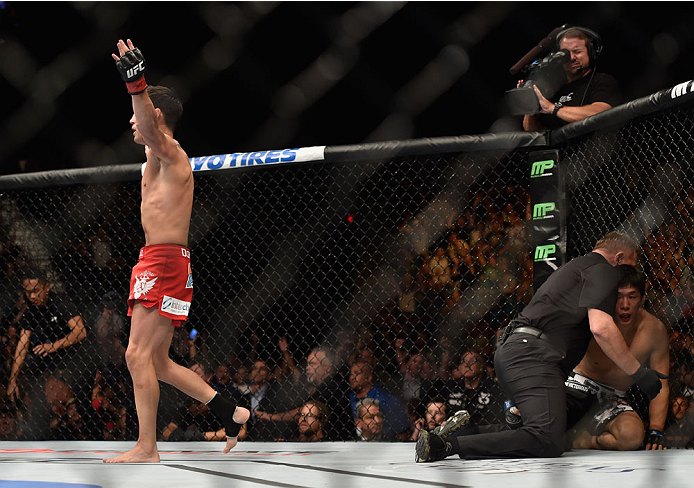LAS VEGAS, NV - SEPTEMBER 27: Dominick Cruz celebrates after his TKO victory over Takeya Mizugaki in their bantamweight fight during the UFC 178 event inside the MGM Grand Garden Arena on September 27, 2014 in Las Vegas, Nevada. (Photo by Jeff Bottari/Z
