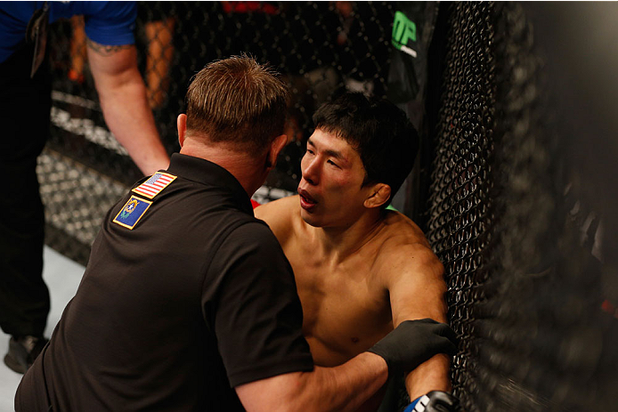 LAS VEGAS, NV - SEPTEMBER 27: Takeya Mizugaki recovers after losing his fight to Dominick Cruz in their bantamweight fight during the UFC 178 event inside the MGM Grand Garden Arena on September 27, 2014 in Las Vegas, Nevada. (Photo by Josh Hedges/Zuffa