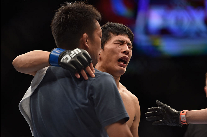 LAS VEGAS, NV - SEPTEMBER 27: Takeya Mizugaki reacts after his TKO loss from Dominick Cruz in their bantamweight fight during the UFC 178 event inside the MGM Grand Garden Arena on September 27, 2014 in Las Vegas, Nevada. (Photo by Jeff Bottari/Zuffa LL