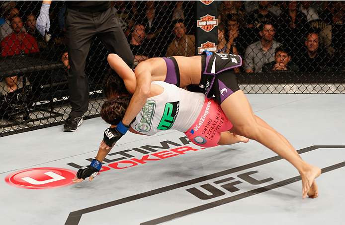 LAS VEGAS, NV - SEPTEMBER 27: (Bottom) Cat Zingano takes down Amanda Nunes in their women's bantamweight fight during the UFC 178 event inside the MGM Grand Garden Arena on September 27, 2014 in Las Vegas, Nevada. (Photo by Josh Hedges/Zuffa LLC/Zuffa L