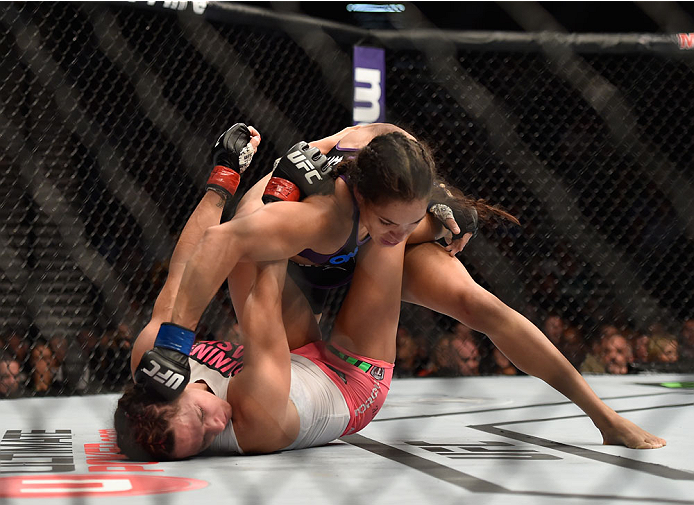 LAS VEGAS, NV - SEPTEMBER 27: (Top) Amanda Nunes punches Cat Zingano in their women's bantamweight fight during the UFC 178 event inside the MGM Grand Garden Arena on September 27, 2014 in Las Vegas, Nevada. (Photo by Jeff Bottari/Zuffa LLC/Zuffa LLC vi