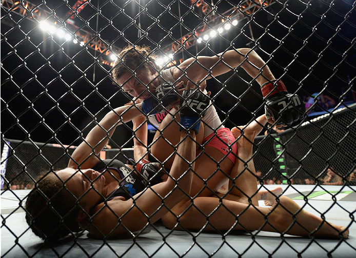 LAS VEGAS, NV - SEPTEMBER 27: (Top) Cat Zingano punches Amanda Nunes in their women's bantamweight fight during the UFC 178 event inside the MGM Grand Garden Arena on September 27, 2014 in Las Vegas, Nevada. (Photo by Jeff Bottari/Zuffa LLC/Zuffa LLC vi