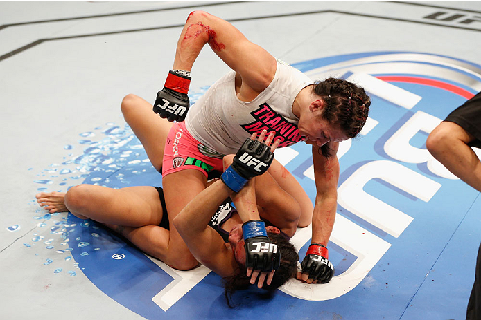 LAS VEGAS, NV - SEPTEMBER 27: (Top) Cat Zingano punches Amanda Nunes in their women's bantamweight fight during the UFC 178 event inside the MGM Grand Garden Arena on September 27, 2014 in Las Vegas, Nevada. (Photo by Josh Hedges/Zuffa LLC/Zuffa LLC via