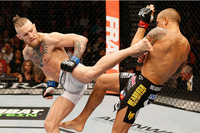 LAS VEGAS, NV - SEPTEMBER 27: (L-R) Conor McGregor kicks Dustin Poirier in their featherweight fight during the UFC 178 event inside the MGM Grand Garden Arena on September 27, 2014 in Las Vegas, Nevada. (Photo by Josh Hedges/Zuffa LLC/Zuffa LLC via Get