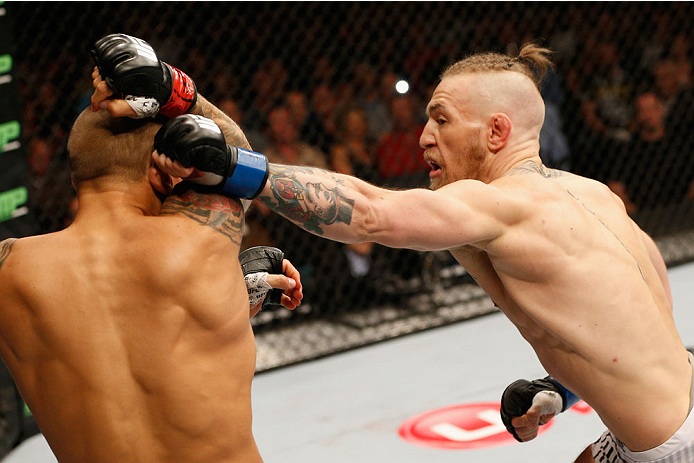LAS VEGAS, NV - SEPTEMBER 27: (L-R) Conor McGregor punches Dustin Poirier in their featherweight fight during the UFC 178 event inside the MGM Grand Garden Arena on September 27, 2014 in Las Vegas, Nevada. (Photo by Josh Hedges/Zuffa LLC/Zuffa LLC via G