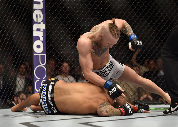 LAS VEGAS, NV - SEPTEMBER 27: (Top) Conor McGregor punches Dustin Poirier in their featherweight fight during the UFC 178 event inside the MGM Grand Garden Arena on September 27, 2014 in Las Vegas, Nevada. (Photo by Jeff Bottari/Zuffa LLC/Zuffa LLC via