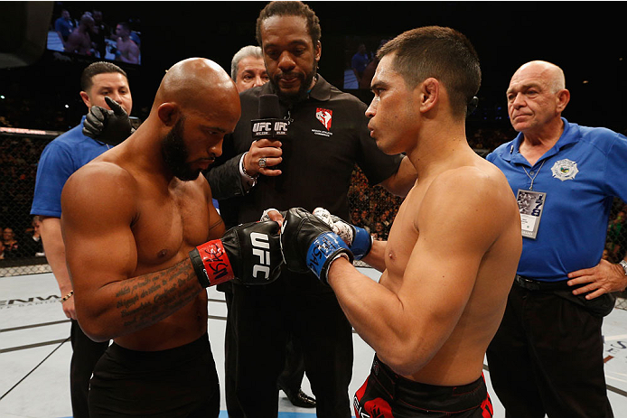LAS VEGAS, NV - SEPTEMBER 27: (L-R) UFC Flyweight champion Demetrious Johnson touches gloves with Chris Cariaso before their flyweight championship fight during the UFC 178 event inside the MGM Grand Garden Arena on September 27, 2014 in Las Vegas, Nevad