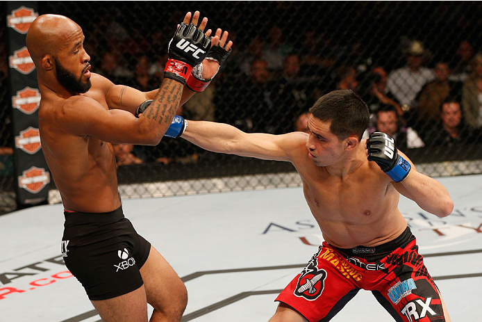 LAS VEGAS, NV - SEPTEMBER 27: (R-L) Chris Cariaso punches Demetrious Johnson in their flyweight championship fight during the UFC 178 event inside the MGM Grand Garden Arena on September 27, 2014 in Las Vegas, Nevada. (Photo by Josh Hedges/Zuffa LLC/Zuf