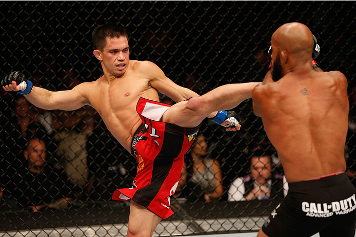 LAS VEGAS, NV - SEPTEMBER 27: (L-R) Chris Cariaso kicks Demetrious Johnson in their flyweight championship fight during the UFC 178 event inside the MGM Grand Garden Arena on September 27, 2014 in Las Vegas, Nevada. (Photo by Josh Hedges/Zuffa LLC/Zuffa