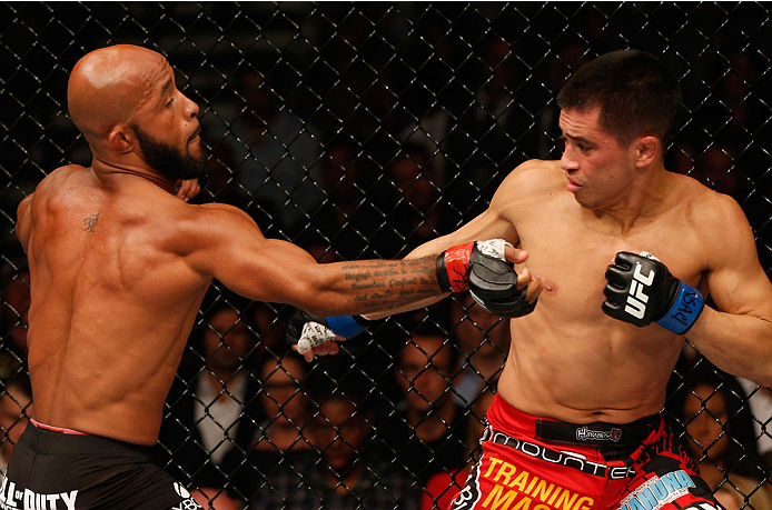 LAS VEGAS, NV - SEPTEMBER 27: (L-R) Demetrious Johnson punches Chris Cariaso in their flyweight championship fight during the UFC 178 event inside the MGM Grand Garden Arena on September 27, 2014 in Las Vegas, Nevada. (Photo by Josh Hedges/Zuffa LLC/Zuf