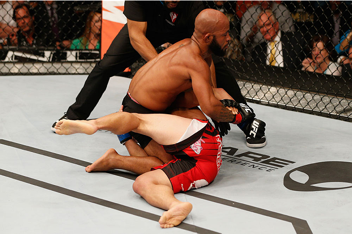 LAS VEGAS, NV - SEPTEMBER 27: UFC Flyweight champion Demetrious Johnson submits Chris Cariaso in their flyweight championship fight during the UFC 178 event inside the MGM Grand Garden Arena on September 27, 2014 in Las Vegas, Nevada. (Photo by Josh Hed