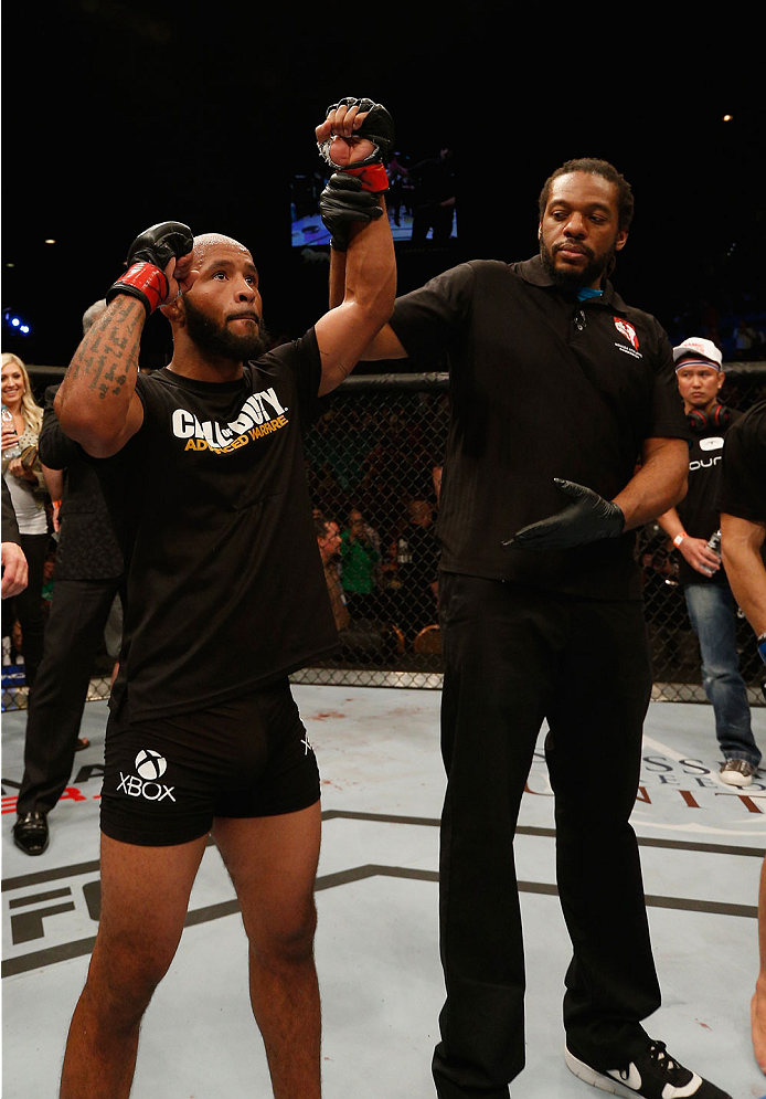 LAS VEGAS, NV - SEPTEMBER 27: UFC Flyweight champion Demetrious Johnson celebrates after his win over Chris Cariaso after their flyweight championship fight during the UFC 178 event inside the MGM Grand Garden Arena on September 27, 2014 in Las Vegas, Ne