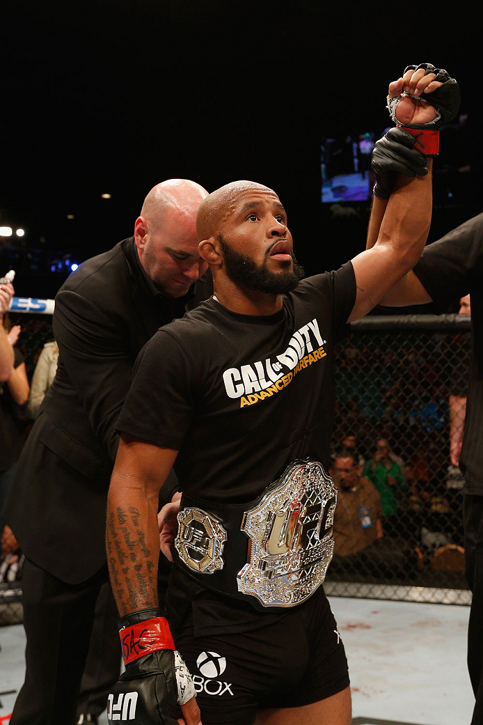 LAS VEGAS, NV - SEPTEMBER 27: UFC Flyweight champion Demetrious Johnson celebrates after his win over Chris Cariaso after their flyweight championship fight during the UFC 178 event inside the MGM Grand Garden Arena on September 27, 2014 in Las Vegas, Ne