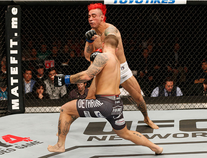 MEXICO CITY, MEXICO - NOVEMBER 15: Chris Heatherly punches Augusto Montano in their welterweight bout during the UFC 180 event at Arena Ciudad de Mexico on November 15, 2014 in Mexico City, Mexico. (Photo by Josh Hedges/Zuffa LLC/Zuffa LLC via Getty Ima