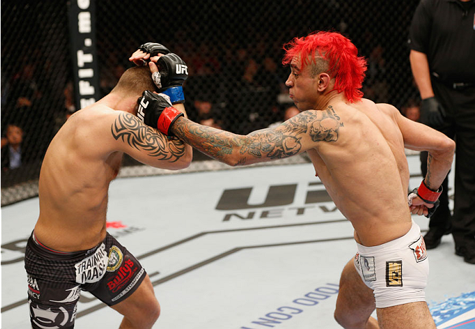 MEXICO CITY, MEXICO - NOVEMBER 15: (R-L) Augusto Montano punches Chris Heatherly in their welterweight bout during the UFC 180 event at Arena Ciudad de Mexico on November 15, 2014 in Mexico City, Mexico. (Photo by Josh Hedges/Zuffa LLC/Zuffa LLC via Get