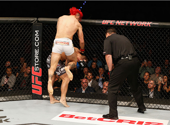 MEXICO CITY, MEXICO - NOVEMBER 15: Augusto Montano knees Chris Heatherly in their welterweight bout during the UFC 180 event at Arena Ciudad de Mexico on November 15, 2014 in Mexico City, Mexico. (Photo by Josh Hedges/Zuffa LLC/Zuffa LLC via Getty Image