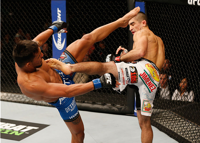 MEXICO CITY, MEXICO - NOVEMBER 15: (R-L) Ricardo Lamas kicks Dennis Bermudez in their featherweight bout during the UFC 180 event at Arena Ciudad de Mexico on November 15, 2014 in Mexico City, Mexico. (Photo by Josh Hedges/Zuffa LLC/Zuffa LLC via Getty