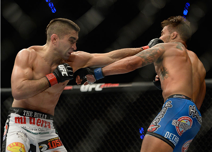 MEXICO CITY, MEXICO - NOVEMBER 15: (L-R) Ricardo Lamas punches Dennis Bermudez in their featherweight bout during the UFC 180 event at Arena Ciudad de Mexico on November 15, 2014 in Mexico City, Mexico. (Photo by Jeff Bottari/Zuffa LLC/Zuffa LLC via Get