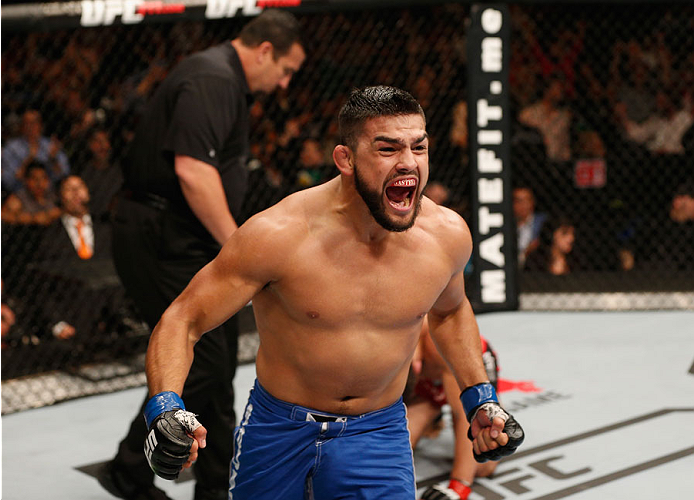 MEXICO CITY, MEXICO - NOVEMBER 15: Kelvin Gastelum celebrates his submission victory over Jake Ellenberger in their welterweight bout during the UFC 180 event at Arena Ciudad de Mexico on November 15, 2014 in Mexico City, Mexico. (Photo by Josh Hedges/Z