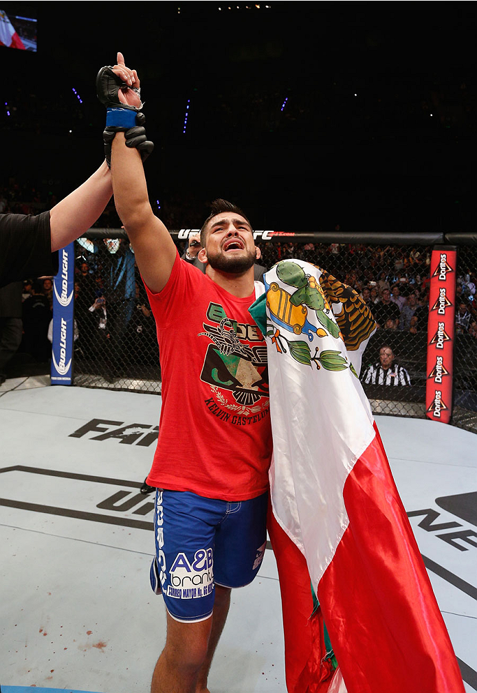 MEXICO CITY, MEXICO - NOVEMBER 15: Kelvin Gastelum celebrates his submission victory over Jake Ellenberger in their welterweight bout during the UFC 180 event at Arena Ciudad de Mexico on November 15, 2014 in Mexico City, Mexico. (Photo by Josh Hedges/Z