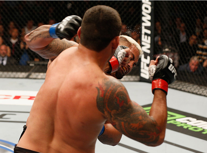 MEXICO CITY, MEXICO - NOVEMBER 15: (R-L) Fabricio Werdum and Mark Hunt trade strikes in their interim UFC heavyweight championship bout during the UFC 180 event at Arena Ciudad de Mexico on November 15, 2014 in Mexico City, Mexico. (Photo by Josh Hedges