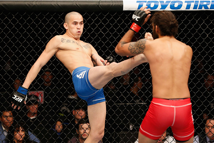 MEXICO CITY, MEXICO - NOVEMBER 15: (L-R) Marlon Vera kicks Marco Beltra in their bantamweight bout during the UFC 180 event at Arena Ciudad de Mexico on November 15, 2014 in Mexico City, Mexico. (Photo by Josh Hedges/Zuffa LLC/Zuffa LLC via Getty Images