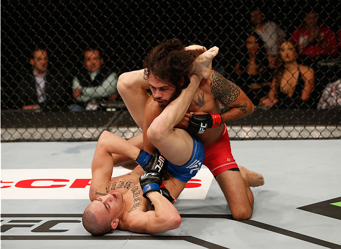 MEXICO CITY, MEXICO - NOVEMBER 15: Marco Beltra (Top) punches Marlon Vera in their bantamweight bout during the UFC 180 event at Arena Ciudad de Mexico on November 15, 2014 in Mexico City, Mexico. (Photo by Josh Hedges/Zuffa LLC/Zuffa LLC via Getty Imag