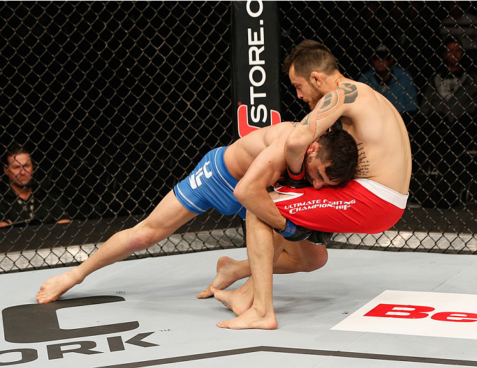 MEXICO CITY, MEXICO - NOVEMBER 15: (L-R) Guido Cannetti takes down Henry Briones in their bantamweight bout during the UFC 180 event at Arena Ciudad de Mexico on November 15, 2014 in Mexico City, Mexico. (Photo by Josh Hedges/Zuffa LLC/Zuffa LLC via Get