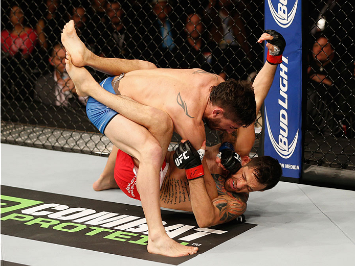 MEXICO CITY, MEXICO - NOVEMBER 15: (Top) Guido Cannetti punches Henry Briones in their bantamweight bout during the UFC 180 event at Arena Ciudad de Mexico on November 15, 2014 in Mexico City, Mexico. (Photo by Josh Hedges/Zuffa LLC/Zuffa LLC via Getty