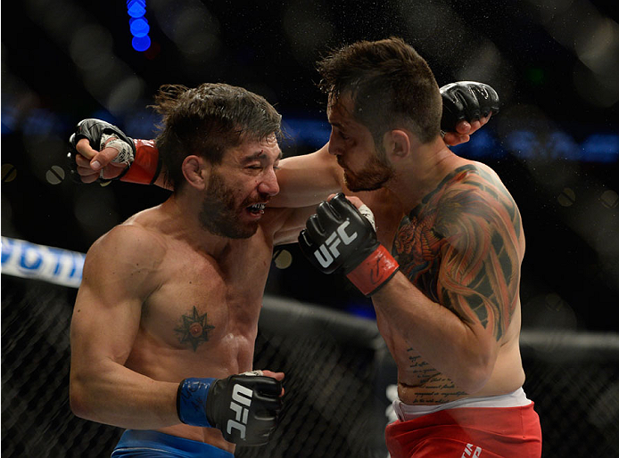 MEXICO CITY, MEXICO - NOVEMBER 15: (L-R) Guido Cannetti exchanges punches with Henry Briones in their bantamweight bout during the UFC 180 event at Arena Ciudad de Mexico on November 15, 2014 in Mexico City, Mexico. (Photo by Jeff Bottari/Zuffa LLC/Zuff