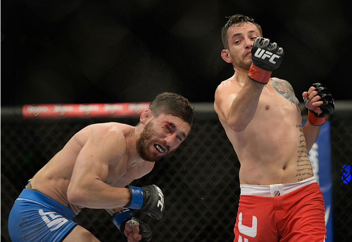 MEXICO CITY, MEXICO - NOVEMBER 15: (R-L) Henry Briones punches Guido Cannetti in their bantamweight bout during the UFC 180 event at Arena Ciudad de Mexico on November 15, 2014 in Mexico City, Mexico. (Photo by Jeff Bottari/Zuffa LLC/Zuffa LLC via Getty