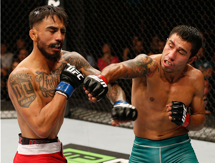 MEXICO CITY, MEXICO - NOVEMBER 15: (R-L) Alejandro Perez exchanges punches with Jose Quinonez in their bantamweight bout during the UFC 180 event at Arena Ciudad de Mexico on November 15, 2014 in Mexico City, Mexico. (Photo by Josh Hedges/Zuffa LLC/Zuff