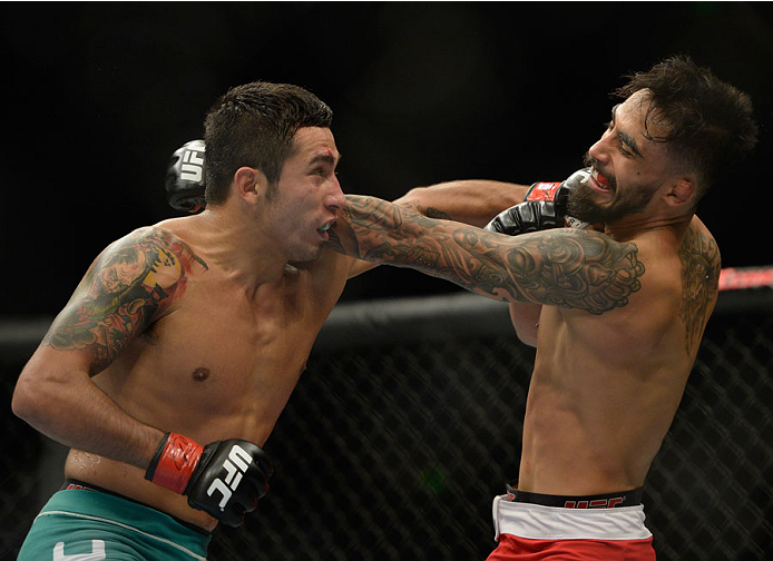 MEXICO CITY, MEXICO - NOVEMBER 15: (R-L) Jose Quinonez exchanges punches with Alejandro Perez in their bantamweight bout during the UFC 180 event at Arena Ciudad de Mexico on November 15, 2014 in Mexico City, Mexico. (Photo by Jeff Bottari/Zuffa LLC/Zuf