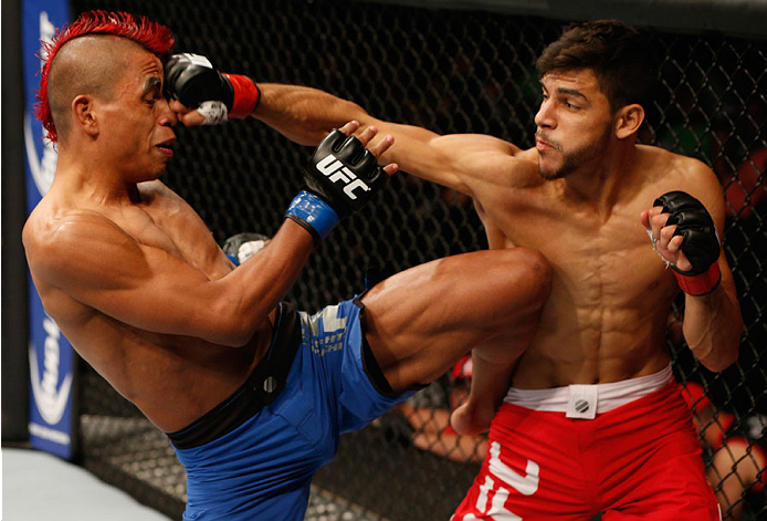 MEXICO CITY, MEXICO - NOVEMBER 15: (R-L) Yair Rodriguez punches Leonardo Morales in their featherweight bout during the UFC 180 event at Arena Ciudad de Mexico on November 15, 2014 in Mexico City, Mexico. (Photo by Josh Hedges/Zuffa LLC/Zuffa LLC via Ge