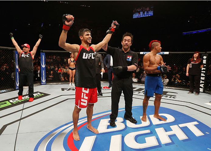 MEXICO CITY, MEXICO - NOVEMBER 15: (L-R) Yair Rodriguez celebrates his victory over Leonardo Morales up against the cage in their featherweight bout during the UFC 180 event at Arena Ciudad de Mexico on November 15, 2014 in Mexico City, Mexico. (Photo b