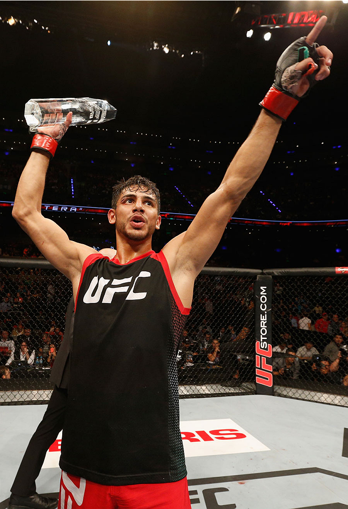MEXICO CITY, MEXICO - NOVEMBER 15: Yair Rodriguez celebrates his victory over Leonardo Morales up against the cage in their featherweight bout during the UFC 180 event at Arena Ciudad de Mexico on November 15, 2014 in Mexico City, Mexico. (Photo by Josh