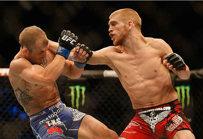 LAS VEGAS, NV - MAY 23: (R-L) Justin Scoggins punches Joshua Sampo in their flyweight bout during the UFC 187 event at the MGM Grand Garden Arena on May 23, 2015 in Las Vegas, Nevada. (Photo by Christian Petersen/Zuffa LLC/Zuffa LLC via Getty Images)