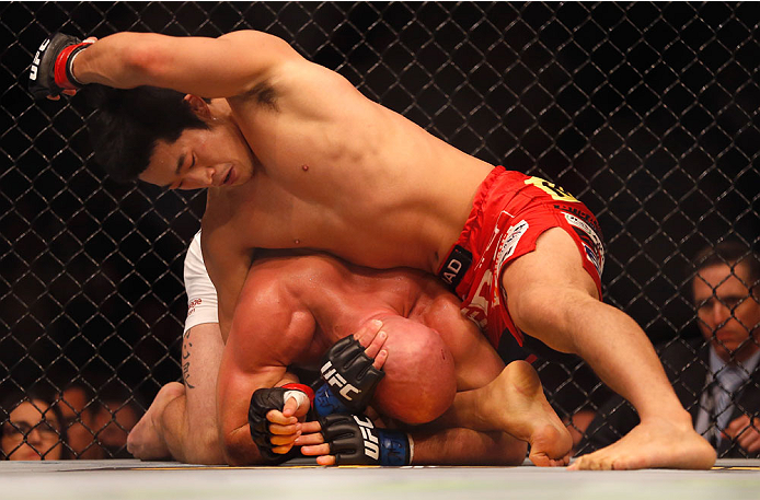 LAS VEGAS, NV - MAY 23: Dong Hyun Kim (top) punches Josh Burkman in their welterweight bout during the UFC 187 event at the MGM Grand Garden Arena on May 23, 2015 in Las Vegas, Nevada. (Photo by Christian Petersen/Zuffa LLC/Zuffa LLC via Getty Images)