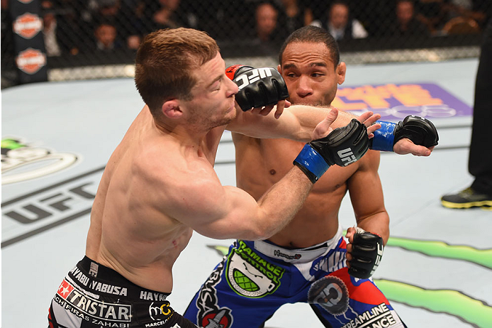 LAS VEGAS, NV - MAY 23: (R-L) John Dodson punches Zach Makovsky in their flyweight bout during the UFC 187 event at the MGM Grand Garden Arena on May 23, 2015 in Las Vegas, Nevada. (Photo by Josh Hedges/Zuffa LLC/Zuffa LLC via Getty Images)
