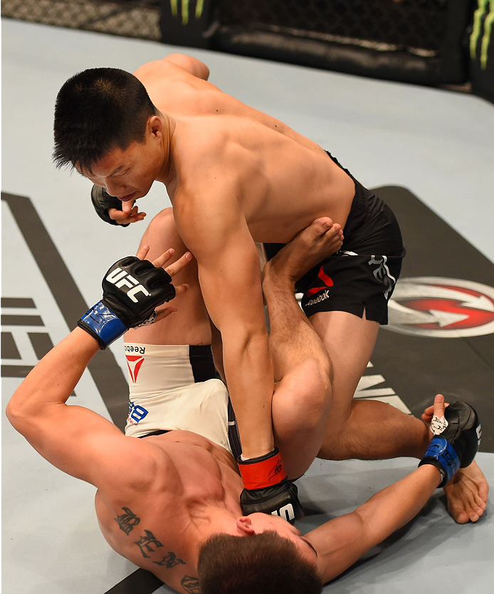 MELBOURNE, AUSTRALIA - NOVEMBER 15: (T-B) Ben Nguyen throws a punch against Ryan Benoit in the first round of their flyweight bout during the UFC 193 event at Etihad Stadium on November 15, 2015 in Melbourne, Australia. (Photo by Josh Hedges/Zuffa LLC/
