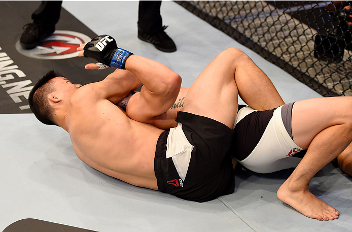 MELBOURNE, AUSTRALIA - NOVEMBER 15: Ben Nguyen puts Ryan Benoit in a rear naked choke to submit him and win in the first round of their flyweight bout during the UFC 193 event at Etihad Stadium on November 15, 2015 in Melbourne, Australia. (Photo by Jos