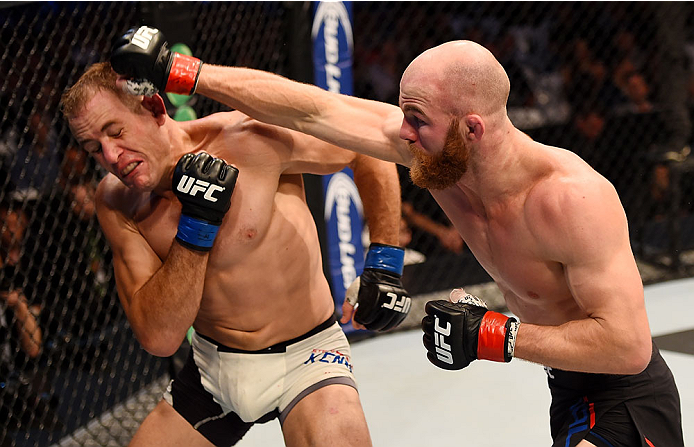MELBOURNE, AUSTRALIA - NOVEMBER 15: Richard Walsh (R) throws a right-handed punch against Steven Kennedy (L) in the third round of their welterweight bout during the UFC 193 event at Etihad Stadium on November 15, 2015 in Melbourne, Australia. (Photo by