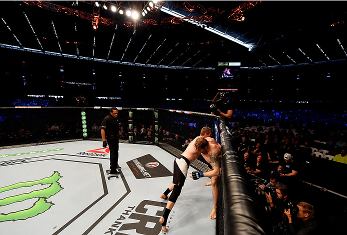 MELBOURNE, AUSTRALIA - NOVEMBER 15: Referee Herb Dean looks on as Daniel Kelly and Steve Montgomery wrestle for position in their middleweight bout during the UFC 193 event at Etihad Stadium on November 15, 2015 in Melbourne, Australia. (Photo by Josh H